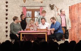 Szene aus dem Stück Patchworklawine: Schauspieler sitzen am Küchentisch