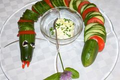 Salatgurke als Schlange dekoriert